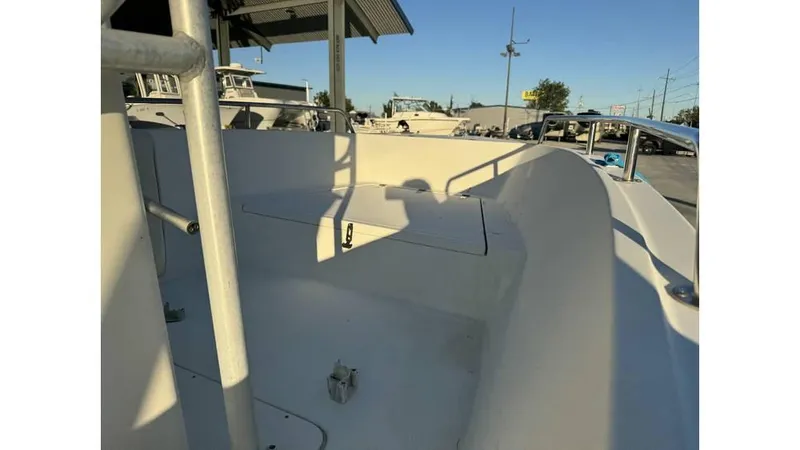 Slide: The Image of 2004 Sea Boss 190 Center Console boat interior, showcasing seating and storage under sunny skies. - 5