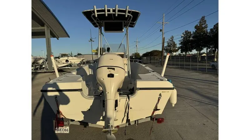 Slide: The Image of 2004 Sea Boss 190 Center Console boat with outboard motor, parked outdoors. - 6