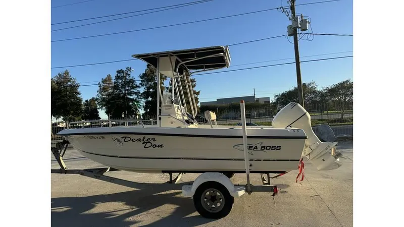 Slide: The Image of 2004 Sea Boss 190 Center Console boat on trailer, parked outdoors. - 9