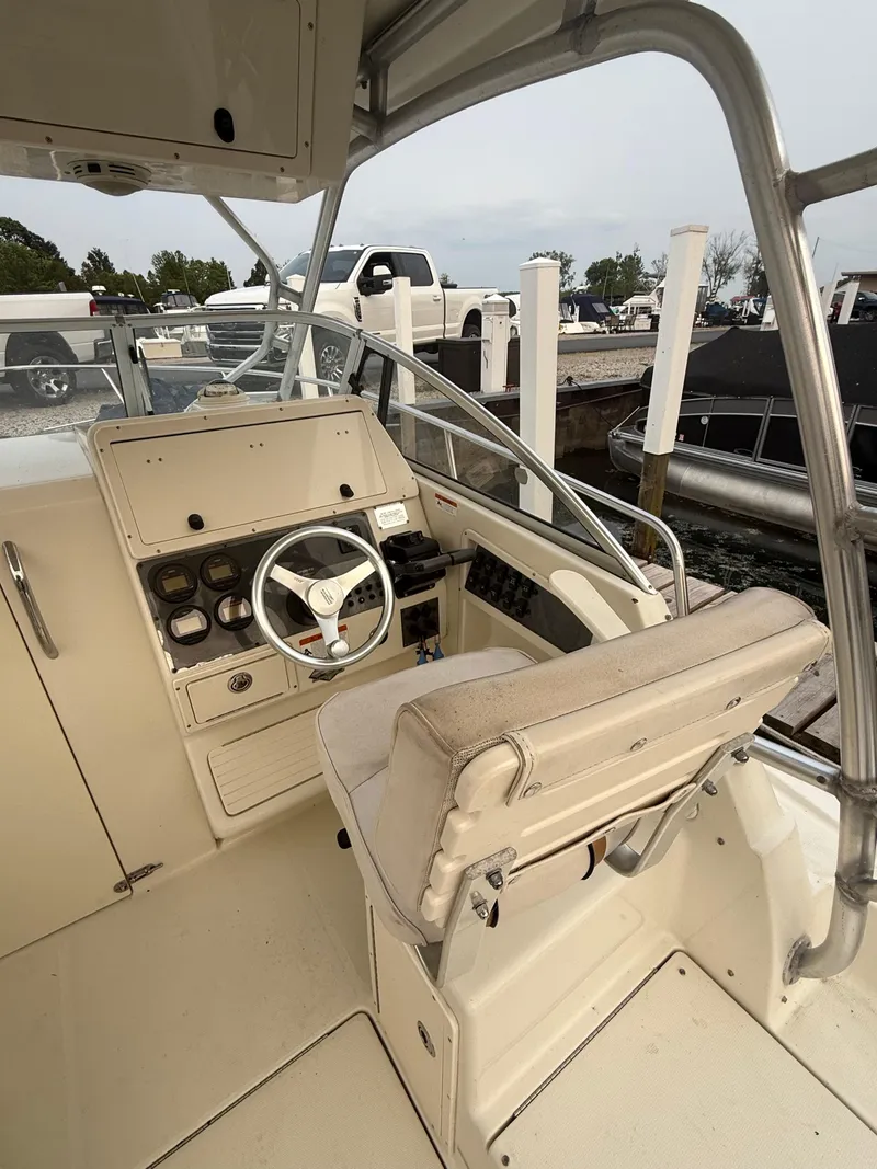 Slide: The Image of 2003 Hydra-Sports Vector 2800 WA boat cockpit with steering wheel and control panel. - 19