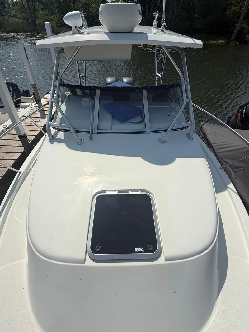 Slide: The Image of 2003 Hydra-Sports Vector 2800 WA boat docked by the water. - 2