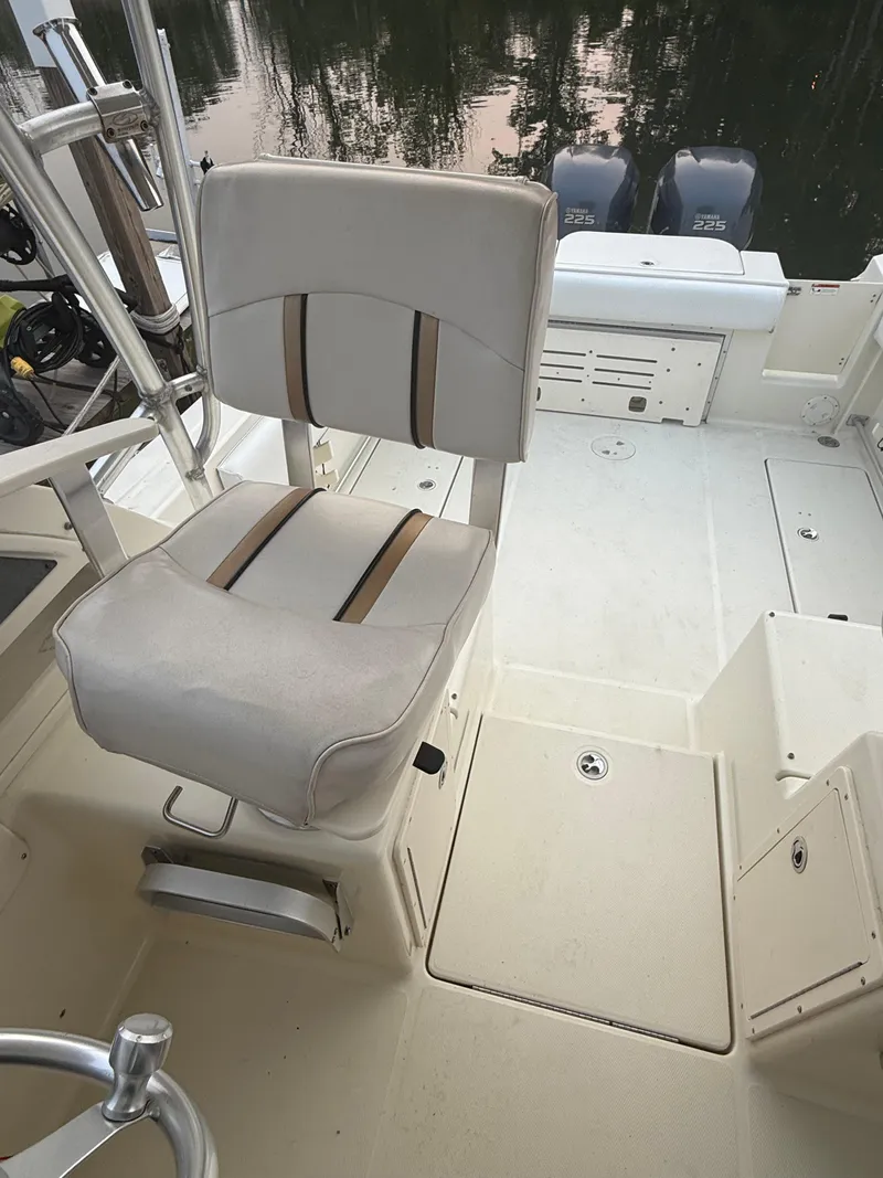 Slide: The Image of 2003 Hydra-Sports Vector 2800 WA boat interior with cushioned seating and dual outboard motors. - 22