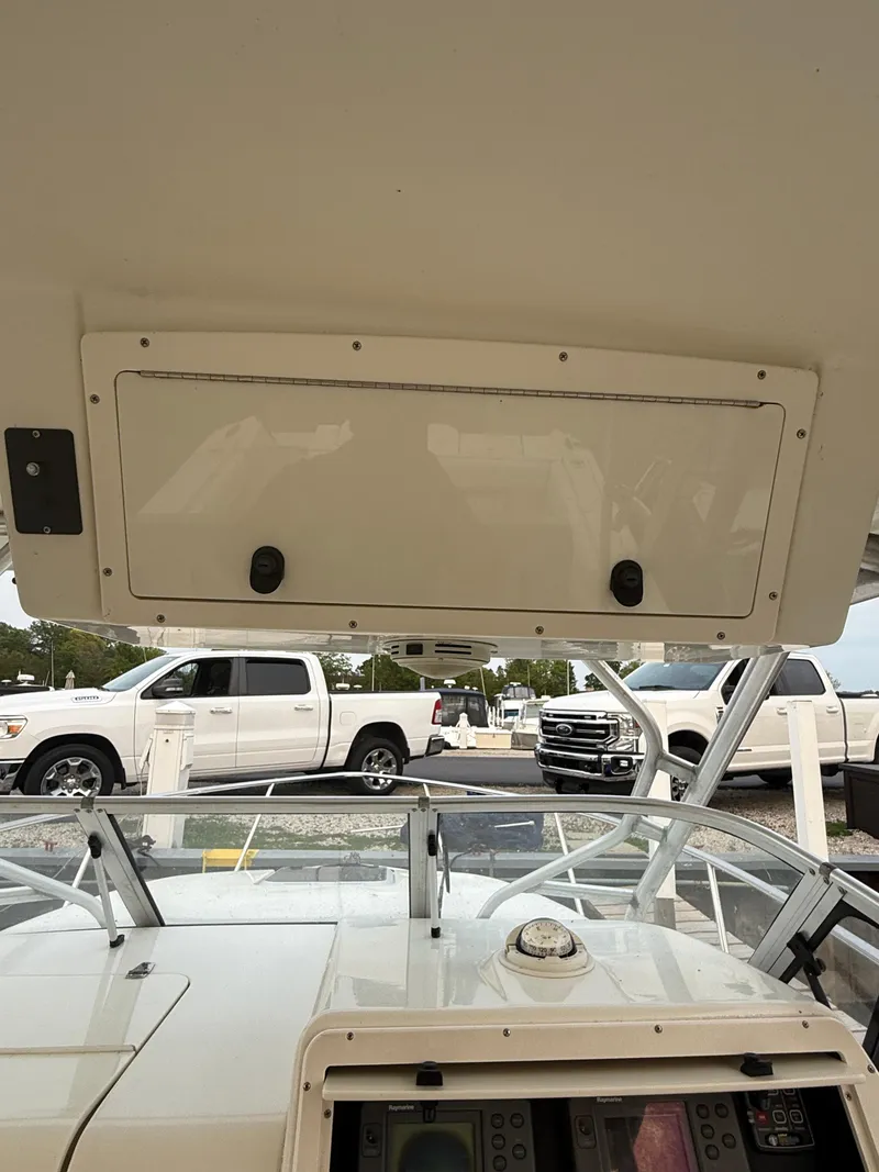 Slide: The Image of 2003 Hydra-Sports Vector 2800 WA boat interior with dashboard and overhead compartment. - 24