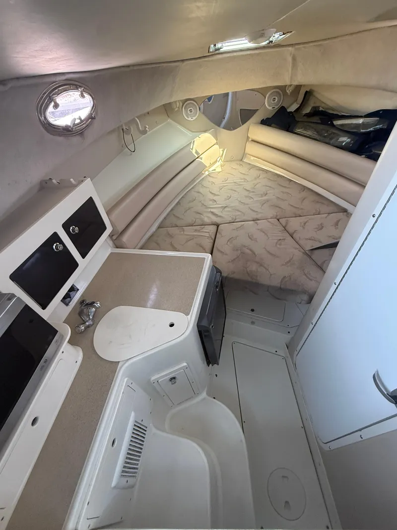 Slide: The Image of 2003 Hydra-Sports Vector 2800 WA cabin interior with seating and kitchenette. - 26