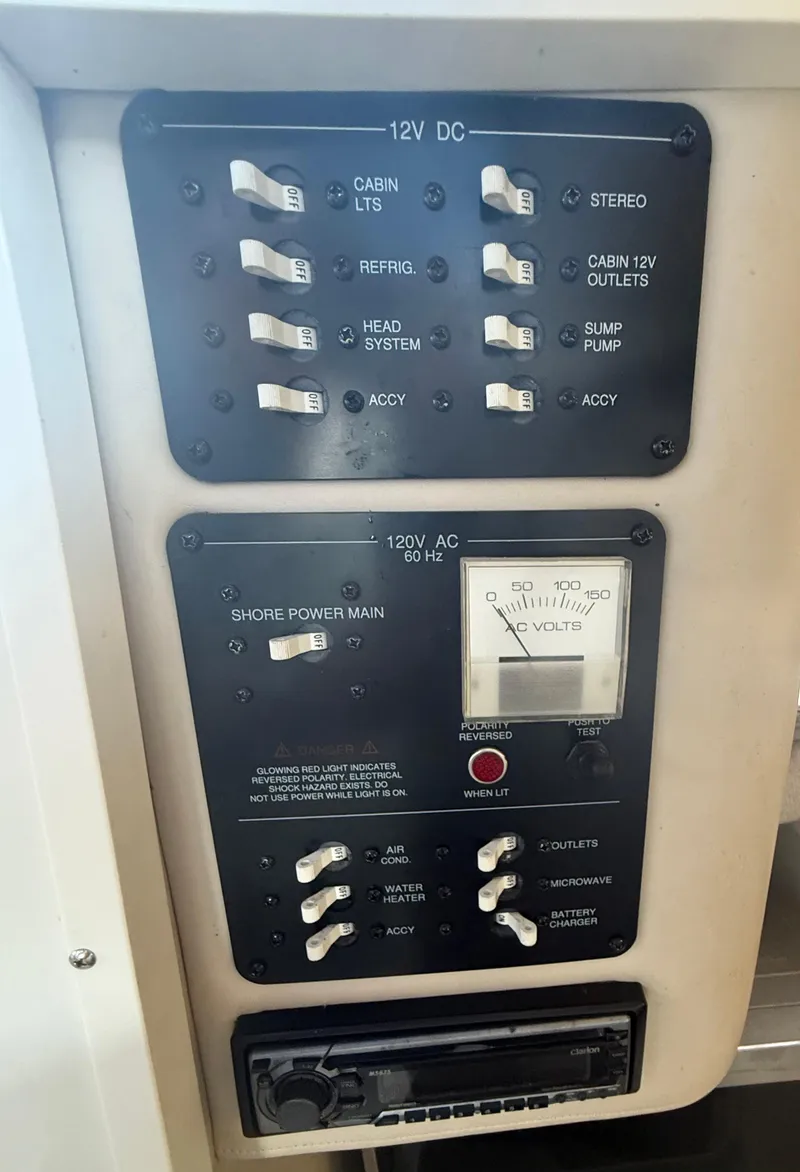 Slide: The Image of Electrical panel of 2003 Hydra-Sports Vector 2800 WA boat with switches and voltmeter. - 27