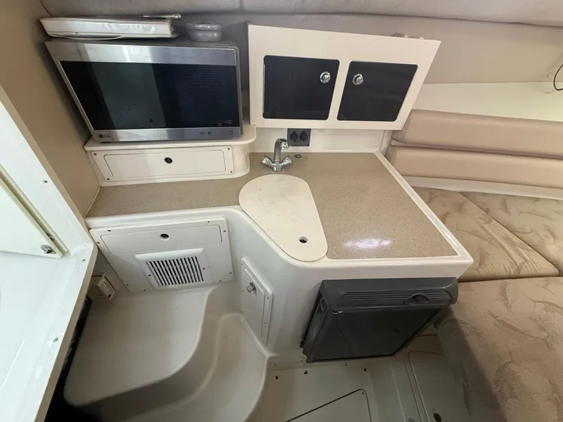 Slide: The Image of 2003 Hydra-Sports Vector 2800 WA cabin interior with kitchenette and seating area. - 28