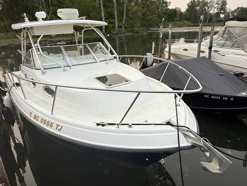 Slide: The Image of 2003 Hydra-Sports Vector 2800 WA boat docked in a serene marina setting. - 3