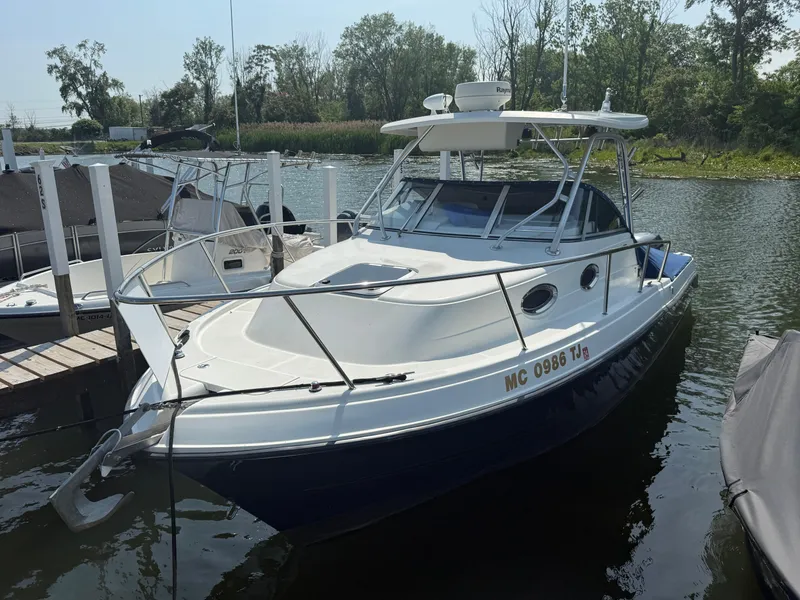 Slide: The Image of 2003 Hydra-Sports Vector 2800 WA boat docked in a serene marina setting. - 32
