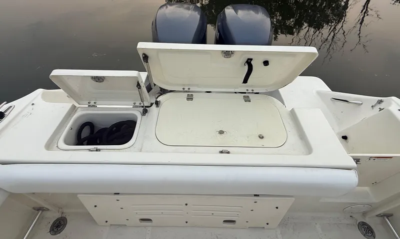 Slide: The Image of 2003 Hydra-Sports Vector 2800 WA boat with open storage compartments and dual engines. - 9