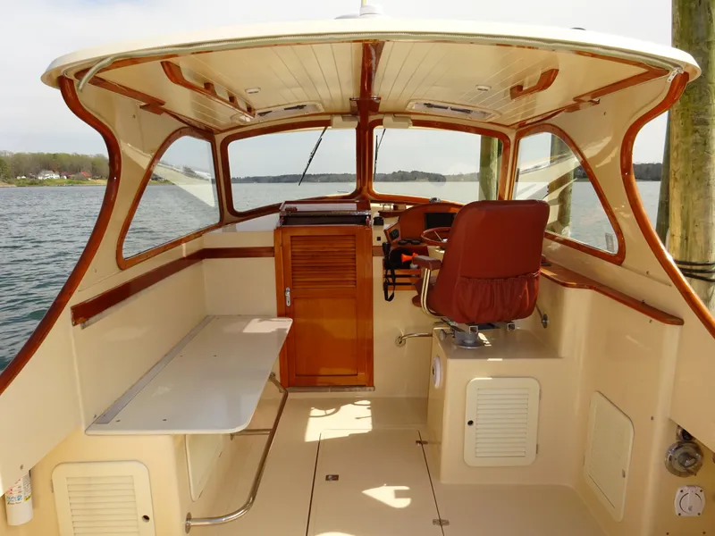 Slide: The Image of 1995 Hinckley Picnic Boat Classic interior with wooden accents and steering wheel. - 13