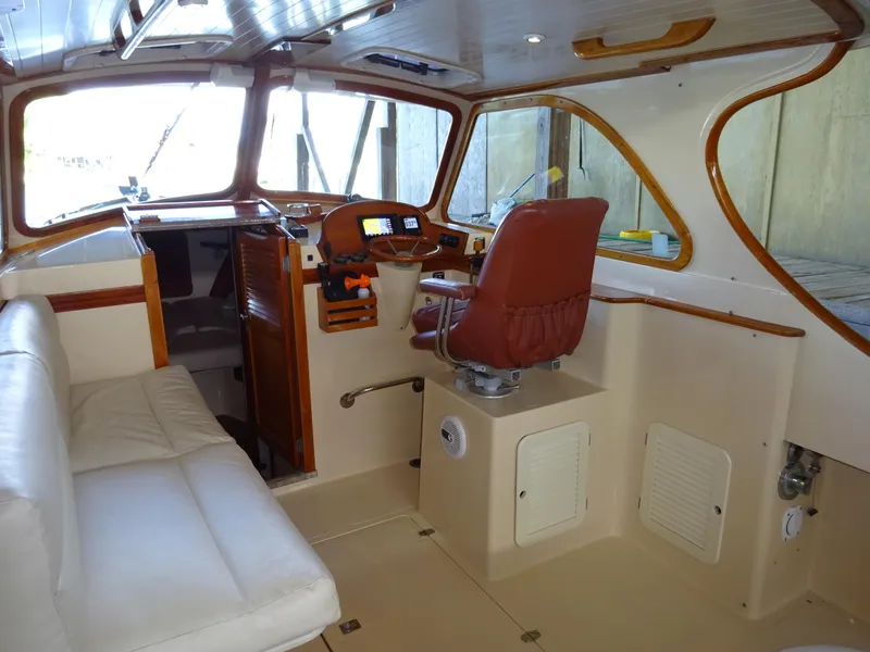 Slide: The Image of Interior of 1995 Hinckley Picnic Boat Classic with leather seating and wooden accents. - 23