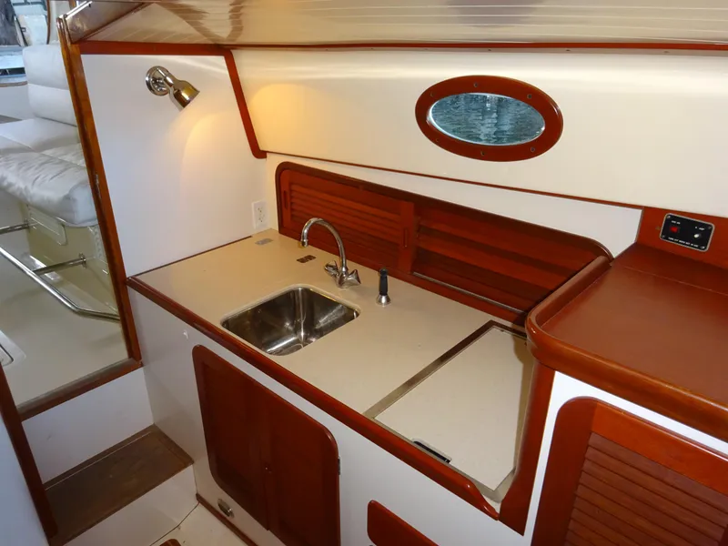 Slide: The Image of Interior of 1995 Hinckley Picnic Boat Classic with compact kitchen and sink. - 29