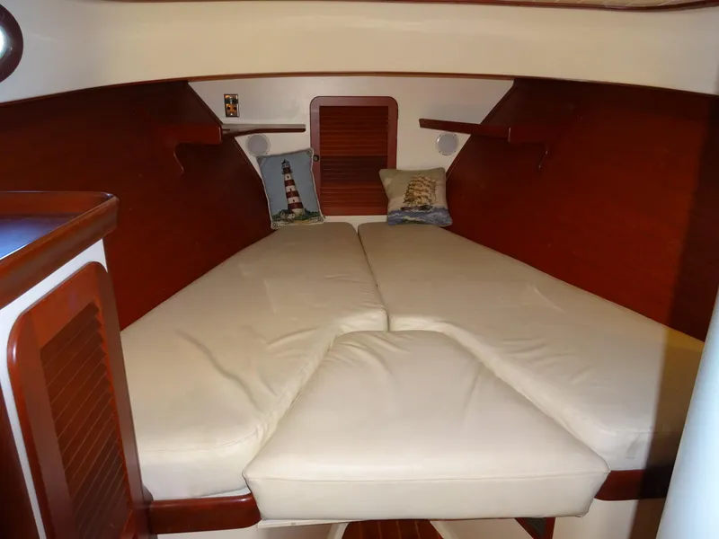 Slide: The Image of Interior cabin of 1995 Hinckley Picnic Boat Classic with cozy beige bedding. - 30