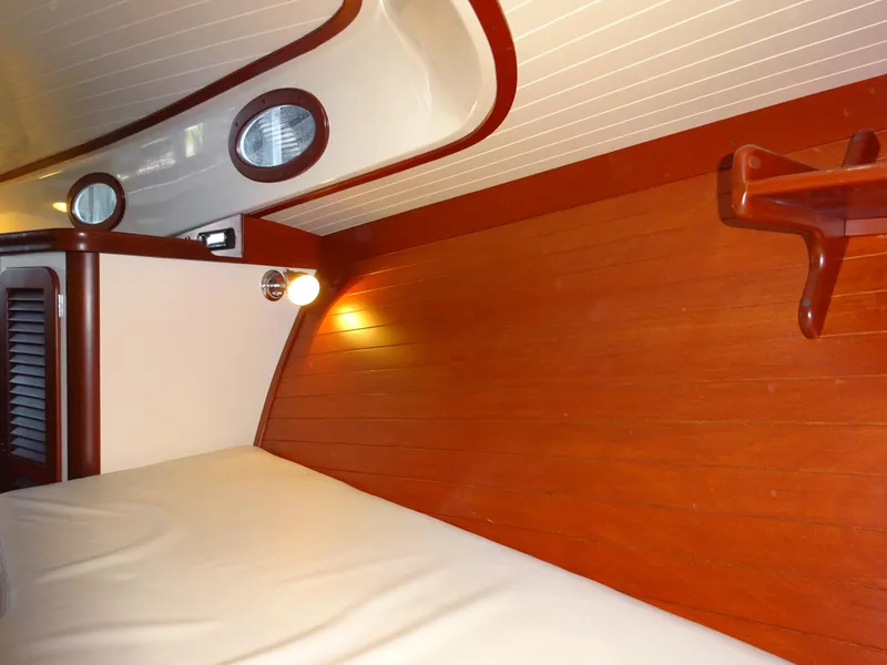 Slide: The Image of Interior of 1995 Hinckley Picnic Boat Classic with wood paneling and cozy lighting. - 34