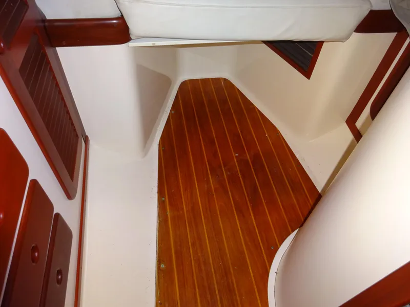 Slide: The Image of Interior of 1995 Hinckley Picnic Boat Classic with wooden flooring and white seating. - 35