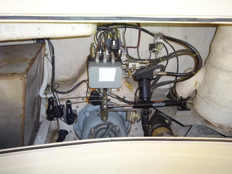 Slide: The Image of Engine compartment of a 1995 Hinckley Picnic Boat Classic, showcasing mechanical components and wiring. - 37