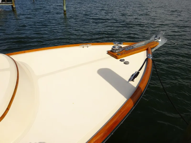 Slide: The Image of Hinckley Picnic Boat Classic 1995 bow with wooden trim on calm water. - 7