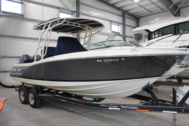 The Image of 2018 Chris-Craft Catalina 26 boat on trailer in indoor storage facility. - 0