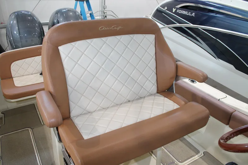 Slide: The Image of 2018 Chris-Craft Catalina 26 boat seat with brown and white diamond-pattern upholstery. - 12