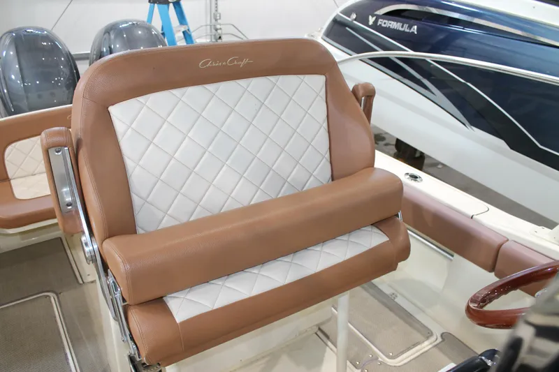 Slide: The Image of 2018 Chris-Craft Catalina 26 boat seat with brown and white quilted upholstery. - 13