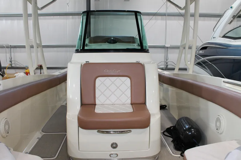 Slide: The Image of 2018 Chris-Craft Catalina 26 boat interior with cushioned seating and windshield. - 24