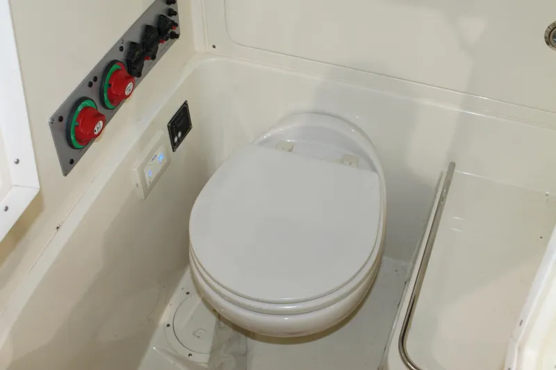 Slide: The Image of 2018 Chris-Craft Catalina 26 boat interior with toilet and control panel. - 26