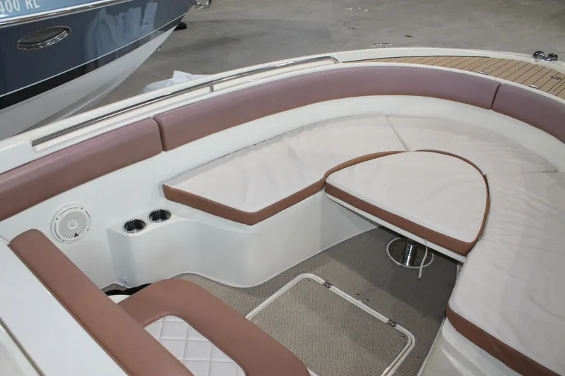 Slide: The Image of 2018 Chris-Craft Catalina 26 interior with cushioned seating and elegant design. - 28