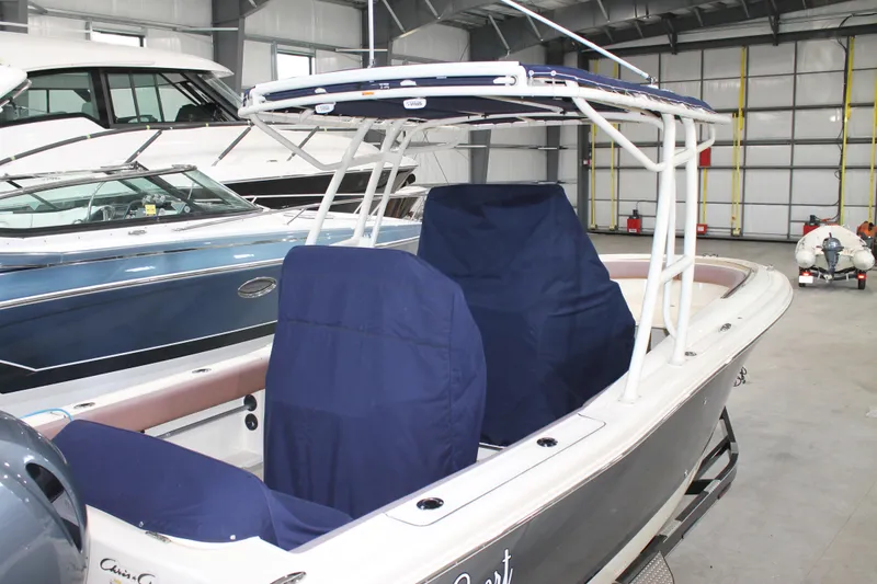 Slide: The Image of 2018 Chris-Craft Catalina 26 boat in storage, featuring blue covers and sleek design. - 3