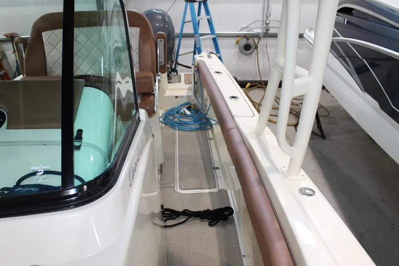 Slide: The Image of 2018 Chris-Craft Catalina 26 boat interior with seating and equipment in a garage setting. - 32
