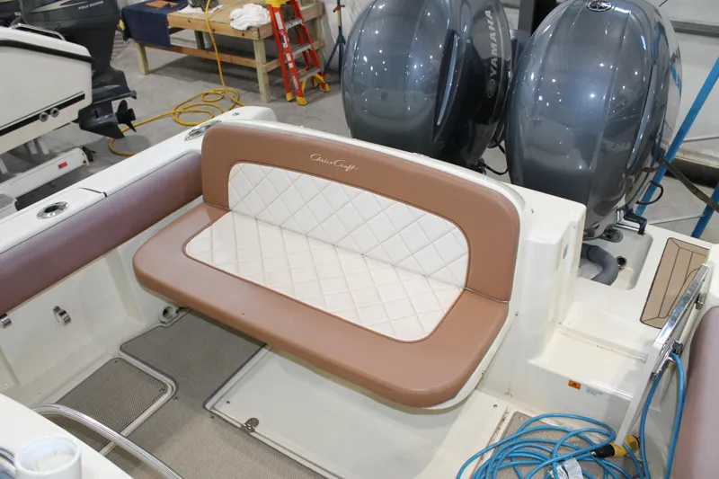 Slide: The Image of 2018 Chris-Craft Catalina 26 boat interior with cushioned seating and dual outboard motors. - 9
