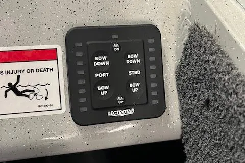 Slide: The Image of Control panel on 2026 Duckworth 22 Pacific Pro boat with safety warning label. - 6