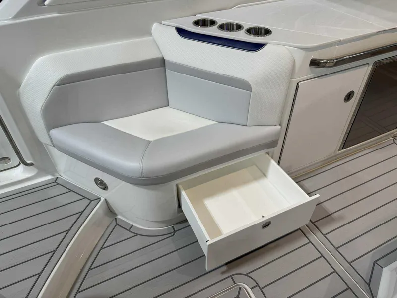 Slide: The Image of 2026 Formula 360 Crossover Bowrider I/O interior with seating, storage drawer, and cup holders. - 20