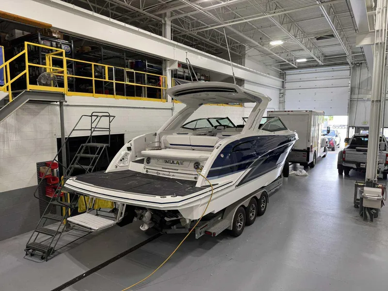 Slide: The Image of 2026 Formula 360 Crossover Bowrider I/O in a garage, showcasing sleek design and modern features. - 4