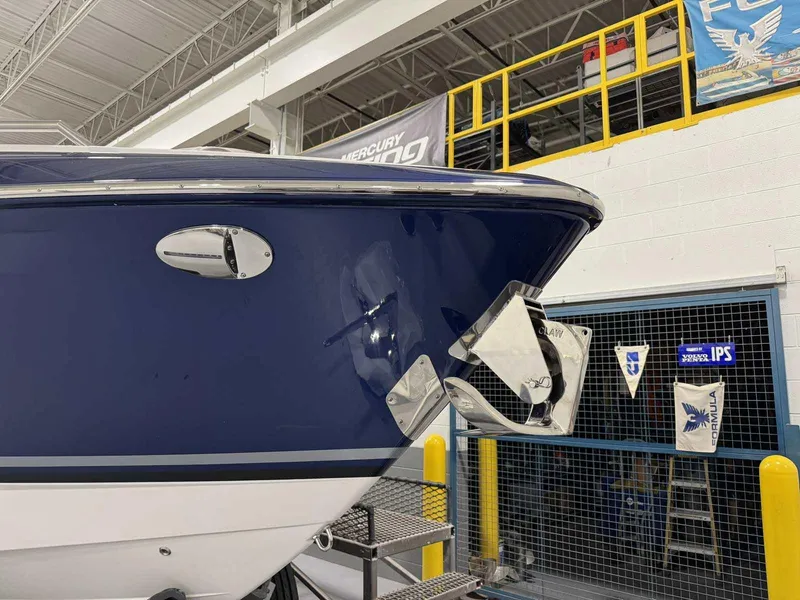 Slide: The Image of 2026 Formula 360 Crossover Bowrider I/O in showroom, showcasing sleek blue hull design. - 5
