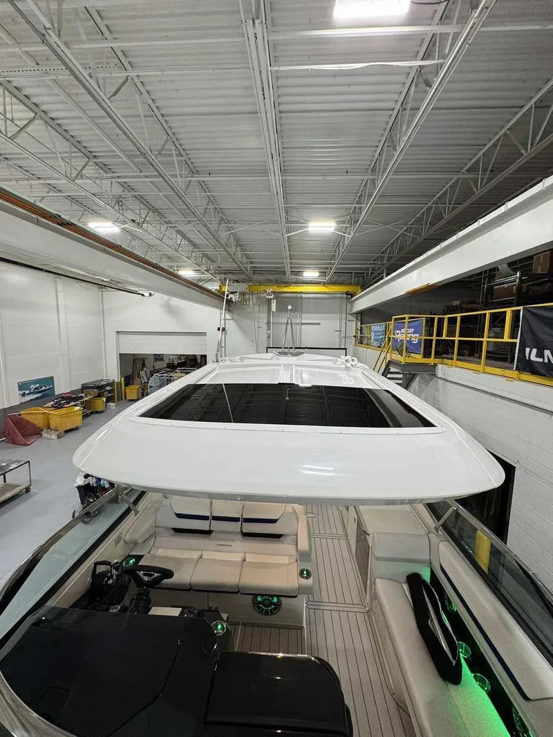 Slide: The Image of 2026 Formula 360 Crossover Bowrider I/O in a spacious indoor facility. - 7