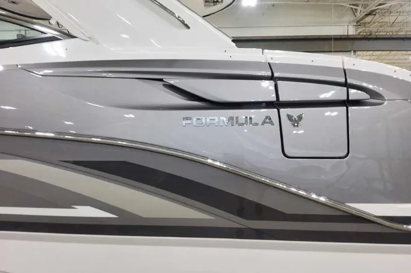 Slide: The Image of 2027 Formula 360 Crossover Bowrider I/O, sleek design with metallic accents and logo. - 10