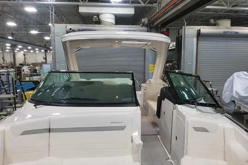 Slide: The Image of 2027 Formula 360 Crossover Bowrider I/O in a factory setting, showcasing sleek design. - 51