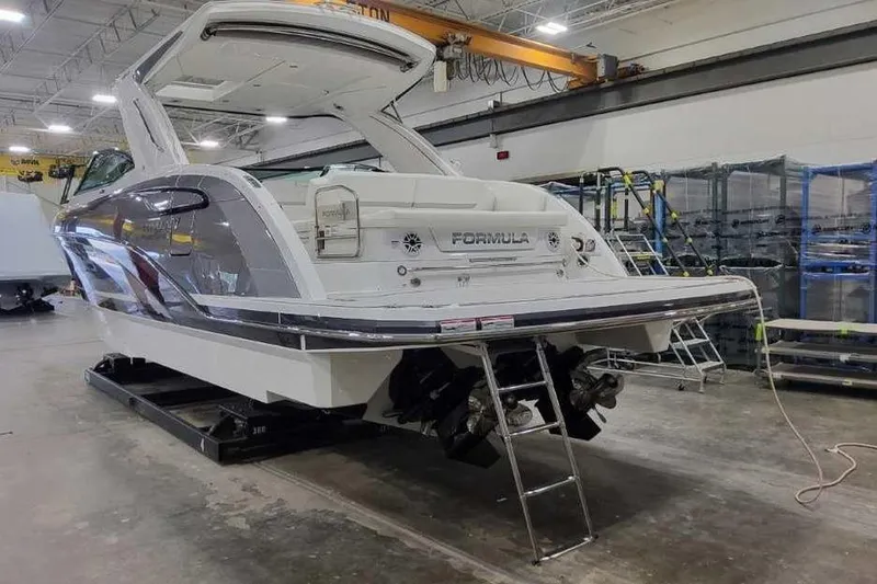 Slide: The Image of 2027 Formula 360 Crossover Bowrider I/O in a showroom, showcasing sleek design and modern features. - 8