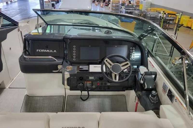 Slide: The Image of 2027 Formula 360 Crossover Bowrider I/O dashboard with modern controls and steering wheel. - 36