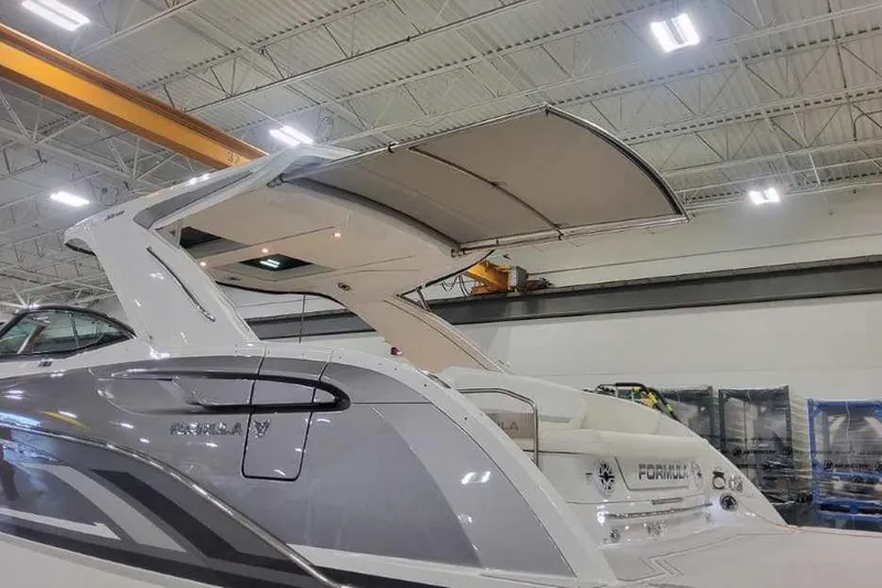 Slide: The Image of 2027 Formula 360 Crossover Bowrider I/O in a showroom, showcasing sleek design and modern features. - 1