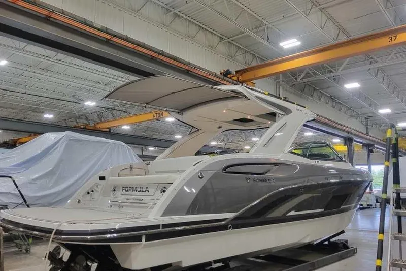 Slide: The Image of 2027 Formula 360 Crossover Bowrider I/O in a warehouse, showcasing sleek design and modern features. - 6