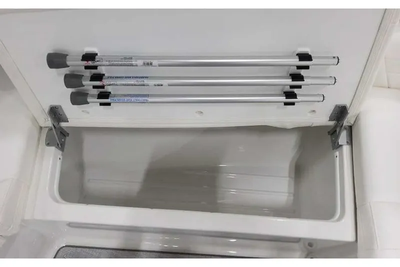 Slide: The Image of Storage compartment in 2027 Formula 360 Crossover Bowrider I/O with mounted rods. - 46