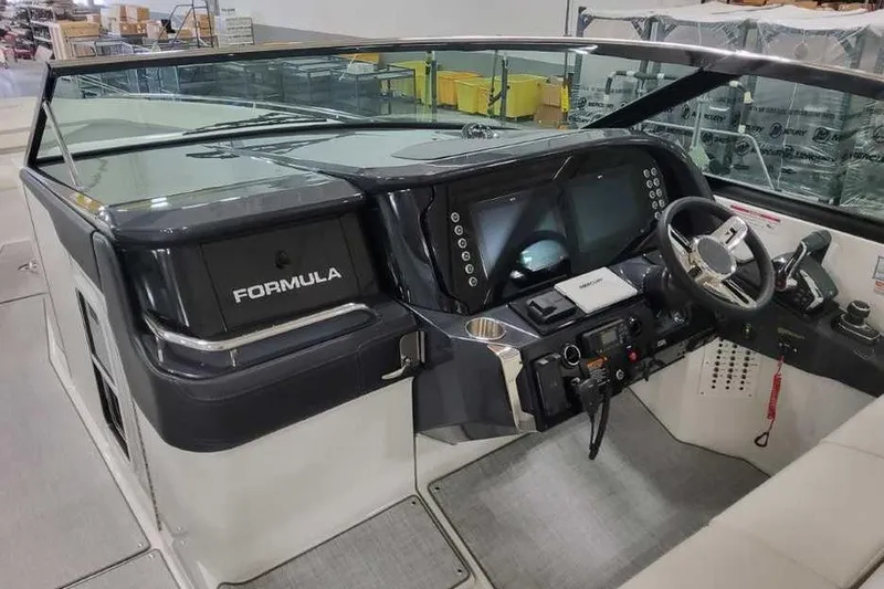 Slide: The Image of 2027 Formula 360 Crossover Bowrider I/O dashboard with modern controls and steering wheel. - 35