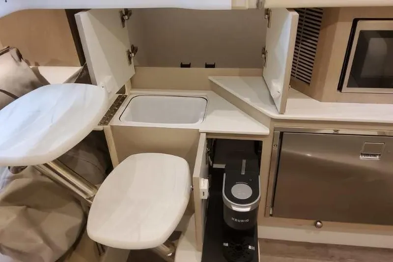 Slide: The Image of Interior of 2027 Formula 360 Crossover Bowrider I/O with kitchenette and seating area. - 65