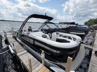 Slide: The Image of 2023 Barletta Corsa 23 UCA pontoon boat docked on a sunny day. - 6