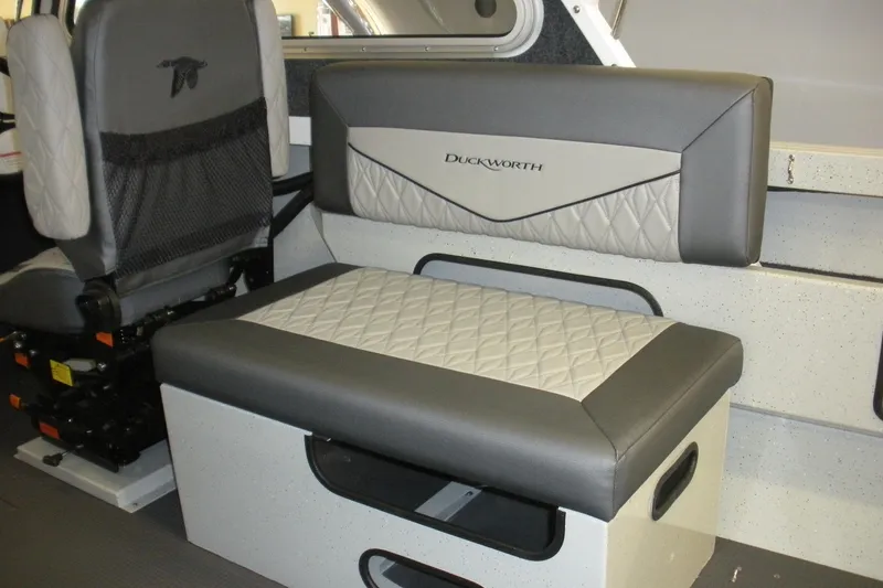 Slide: The Image of Interior seating of 2026 Duckworth 21 Discovery boat, featuring quilted upholstery and modern design. - 10