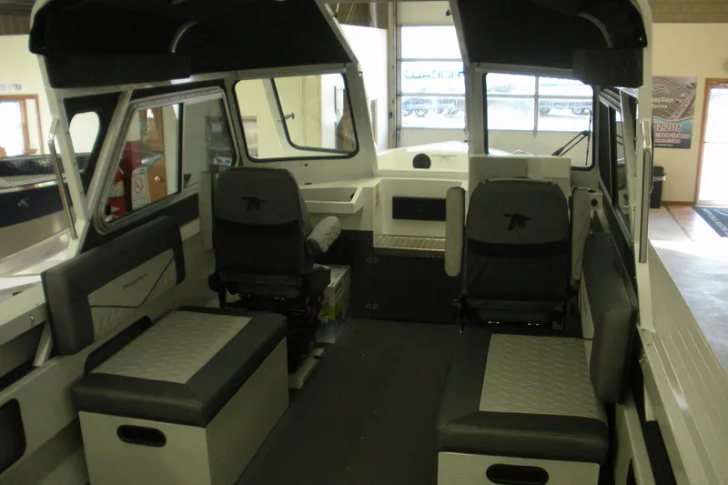 Slide: The Image of Interior of a 2026 Duckworth 21 Discovery boat with seating and helm. - 12