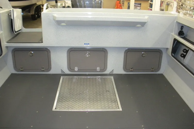 Slide: The Image of Interior of 2026 Duckworth 21 Discovery boat with storage compartments and metal floor panel. - 15