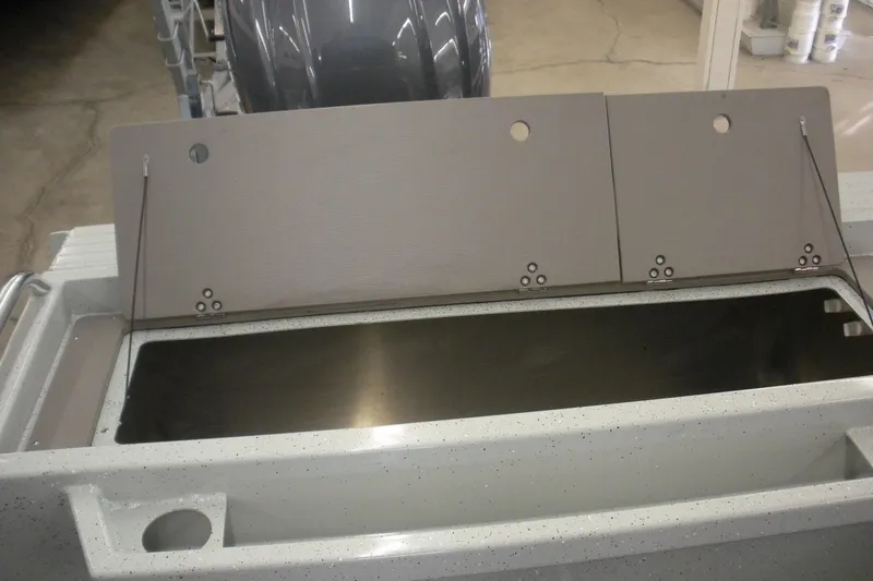 Slide: The Image of 2026 Duckworth 21 Discovery boat storage compartment with open lid, showcasing interior space. - 17