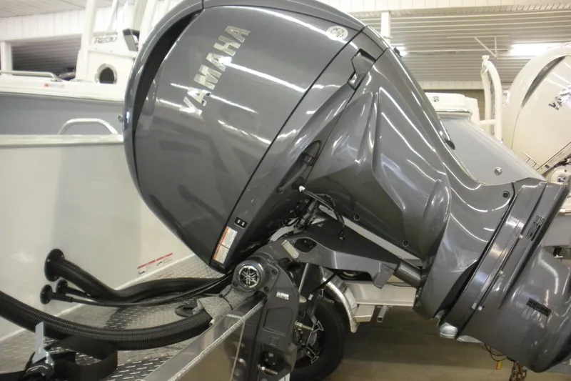Slide: The Image of Yamaha outboard motor on a 2026 Duckworth 21 Discovery boat, displayed indoors. - 21